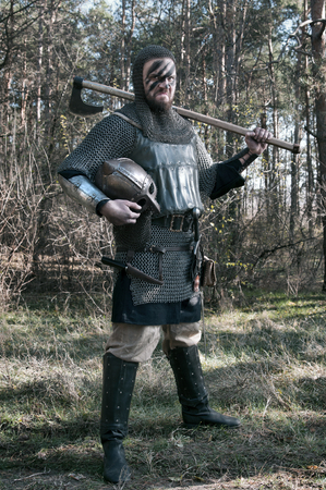 Brave warrior viking in the autumn forest.の写真素材