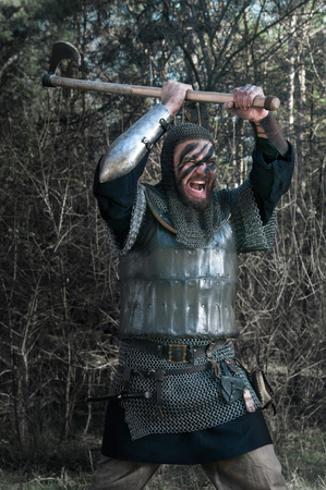 Brave warrior viking in the autumn forest.の写真素材