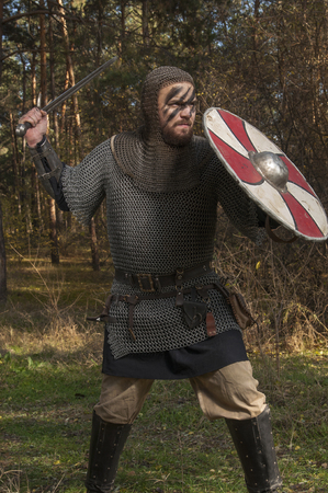 Brave warrior viking in the autumn forest.の写真素材