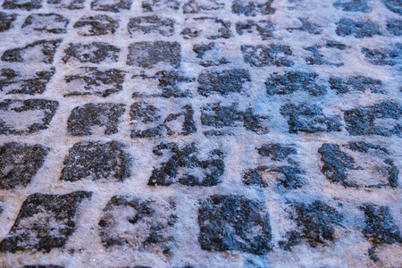Photo of pavers strewn snow. Winter night.の写真素材