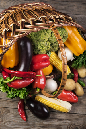 Photography of different vegetables on wooden table in basket. Healthy food background.の写真素材
