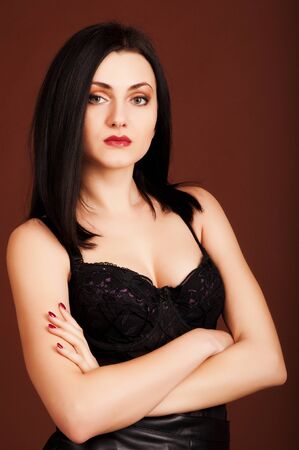 Hot brunette woman on the brown background.の写真素材