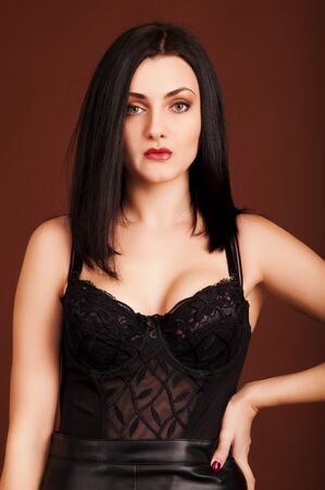 Hot brunette woman on the brown background.の写真素材