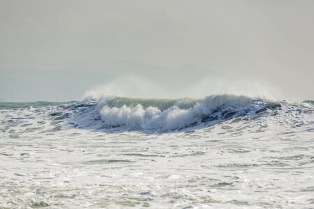 storm waves in the Black sea. The waves are in several rows, sea foam, whitecaps, wind. Background.