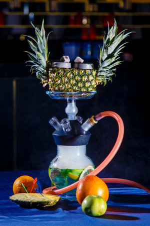 Hookah on pineapple. Pineapple hookah. Hookah with round clear bulb in which the red liqueur float...