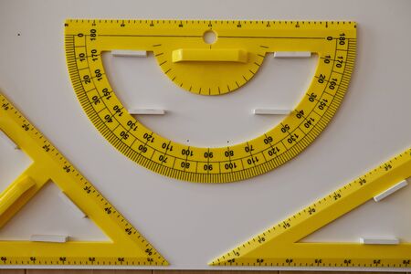 School large yellow protractor and two triangles.