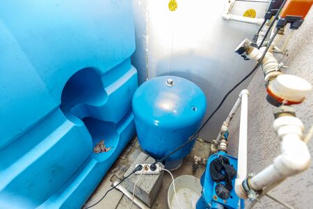 water tanks and pumps for water supply in the basement of the cottage.
