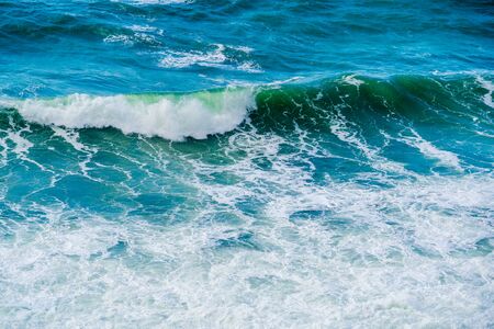 Turquoise waves with foam in the Black sea.