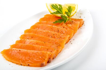 Salted salmon with butter and lemon. Plate on a white background.の写真素材