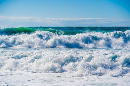 Beautiful storm waves in white foam in the Black sea. A sea of interesting emerald hueの写真素材