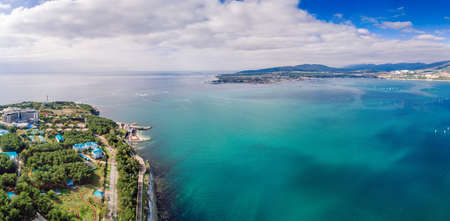 Panorama of Gelendzhik resort from a drone. The city of Gelendzhik on the shore of Gelendzhik Bay at the foot of the mountains. Numerous white sails in the emerald water of the Black Seaの写真素材