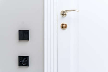 Stylish bronze door handle and lock on a white new interior door.の写真素材