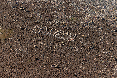 The inscription is laid out with stones on the beachの写真素材