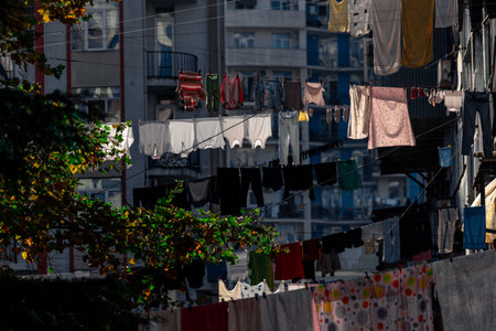 Clothes are dried on ropes hanging between apartment buildings.の写真素材