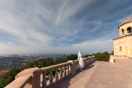 a girl looks at the panorama of Batumi from the Sameba mountain.