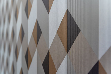 A patterned wallpaper with brown and white squares. The pattern is made up of squares and trianglesの写真素材