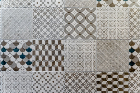 A tile pattern with a variety of shapes and designs. The tiles are arranged in a way that creates a...