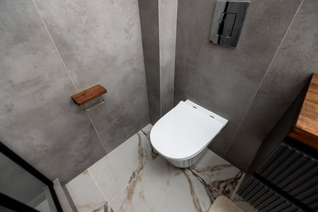 interior of modern bathroom with white ceramic toilet bowl, modern design