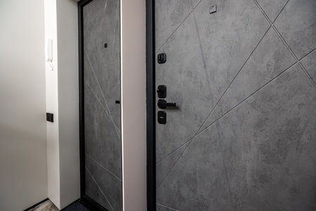 Two doors with a black frame and a gray color. The doors are next to each other. The doors are made of metalの写真素材