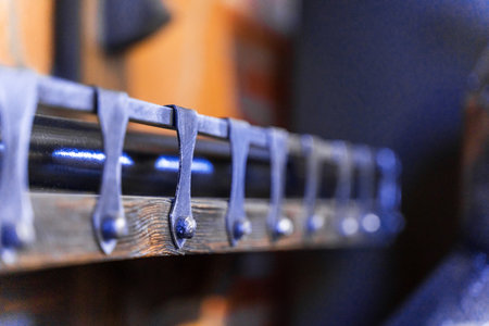 A wooden door with a black metal latch. The latch is attached to the door with a metal bracket. The door is surrounded by wooden trim, giving it a rustic appearance. Scene is warm and invitingの写真素材