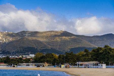 Gelendzhik resort in winter. Nord-Ost wind begins. Signs of storm - clouds over Caucasus Mountains. Off-season. Deserted beach, strong wind.の写真素材