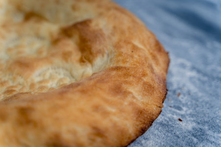Two round breads with a crust on top. The crust is brown and the bread is slightly burnt