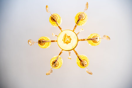 A large chandelier with many gold and blue lights hanging from it. The chandelier is hanging from...