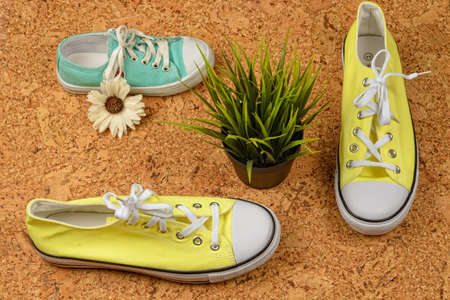 yellow sneakers on a background of cork