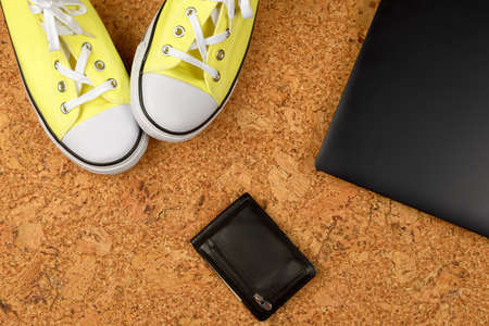 yellow sneakers on a background of cork