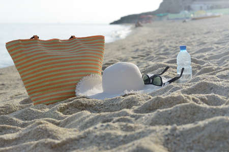 Women's beach accessories on sandの写真素材