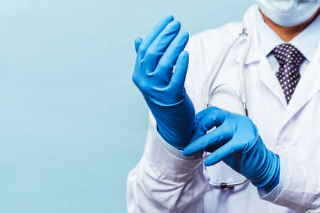doctor puts on rubber gloves, healthcare and medicine.