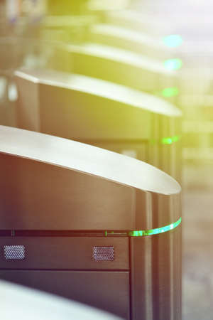 Turnstiles in the subway. Access system of public transport in the city. Urban image.