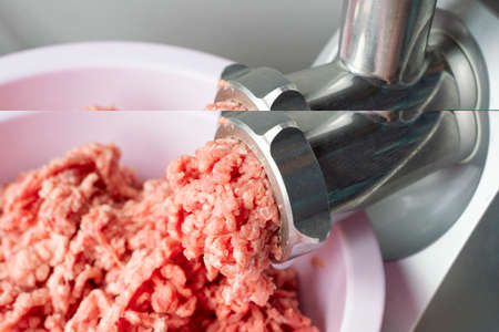 Close up of front part of meat grinder or mincing-machine with mincemeat in. Showing the forcemeat process.の写真素材
