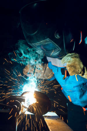 Welders working at the factory made metal