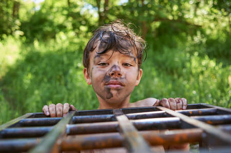 Funny, cute dirty and boy - got dirty in sootの写真素材