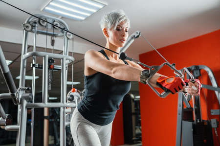 beautiful muscular fit woman exercising building muscles