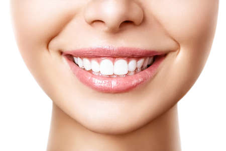 Beautiful female smile after teeth whitening procedure. Dental care. Dentistry concept.の写真素材