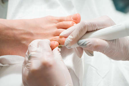 A Podiatrist doctor who takes care of a womans toenails. Cosmetic procedures of the feet