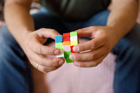 Moscow Russia October 10, 2021. Male hands holding Rubiks cube close up Rubiks cube invented by a Hungarian architect Erno Rubik in 1974.のeditorial素材