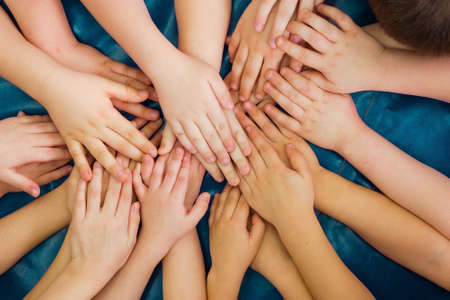 Team building. Childrens hands. Group activity for children. The concept of achieving a common goal...