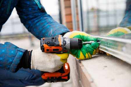 The wizard is engaged in installing windows. Repair work.の写真素材