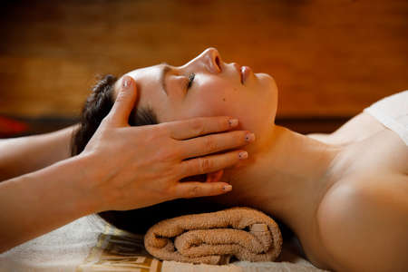Young woman in a spa salon. Facial massage procedure.
