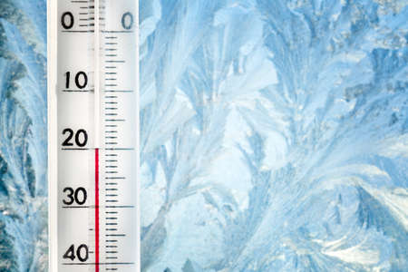 The thermometer shows a low temperature of minus 20 Celsius. Weather forecast. A frosty day and ice...