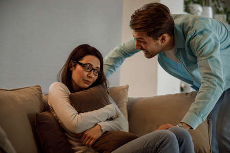 Young couple having argument-conflict, bad relationships. Angry men yells at a woman.の写真素材