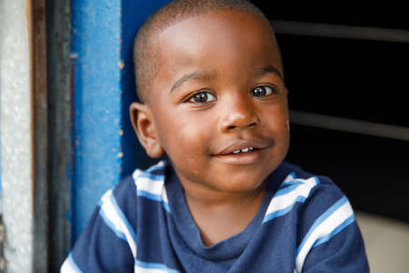 2022.03.14 Dominican Republic Punta Cana Bavaro. Portrait of a child. A little African-American boy looks into the camera and smiles. Dominican people.のeditorial素材