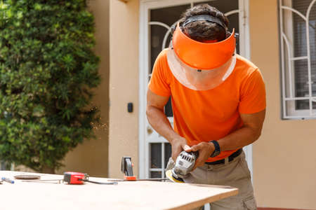 A man in his yard is engaged in locksmith work. Hobby, in a home workshop.の写真素材