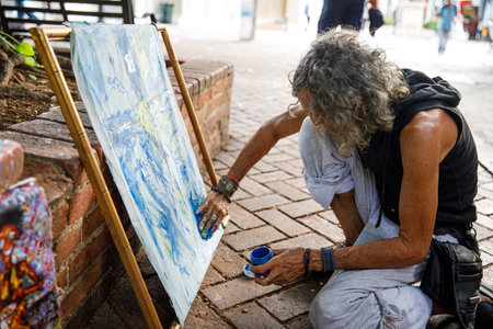 30.06.2022 Street artist in the Dominican Republic draws Jesus Christ on the cross. Santo Domingo Columbus Park, Colonial Zone.のeditorial素材