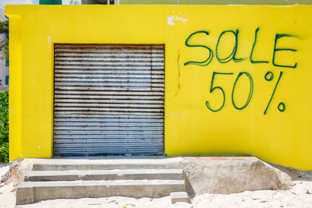 The inscription on the yellow wall with a sale 50