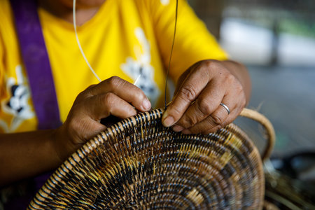 Mangyan Village Talipanan Oriental Mindoro Philippines closeup of hands weaving basket from bamboo fibersの写真素材