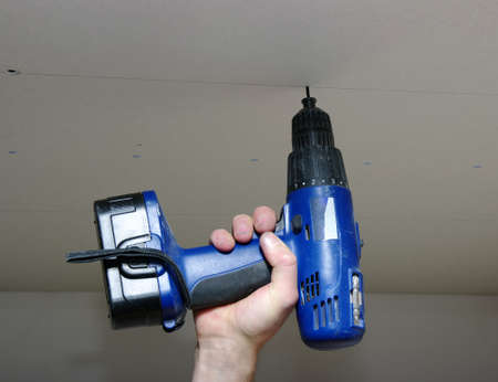 Construction worker holding the hand drill 
